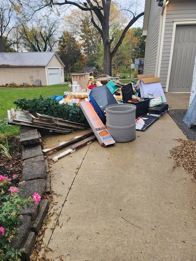 Dumpster being loaded with debris for Residential Dumpster Rental in Tipton